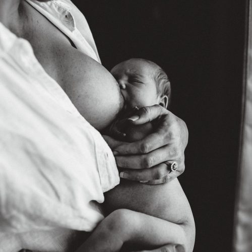 Baby being breastfed by mum