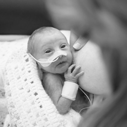 Premature baby being breast fed